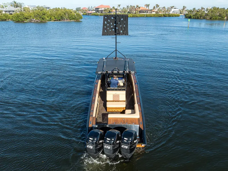 Slide: The Image of 2005 Midnight Express 39S Open boat with triple engines cruising on a calm waterway. - 40