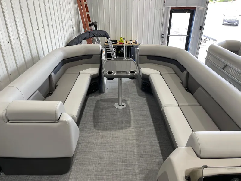 Slide: The Image of 2025 Princecraft Vectra 25 RL pontoon boat interior with gray seating and central table. - 10