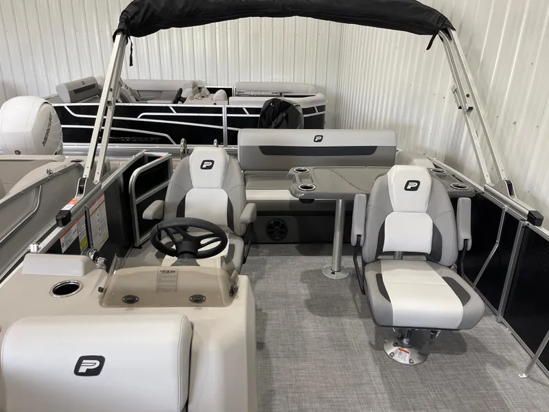 Slide: The Image of 2025 Princecraft Vectra 25 RL pontoon boat interior with seating and steering console. - 11