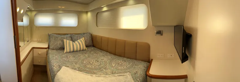 Slide: The Image of Cozy bedroom in 1993 Silverton 34 Aft Cabin Motor Yacht with elegant bedding and modern decor. - 10