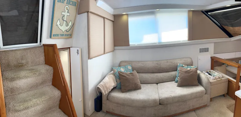 Slide: The Image of Interior of 1993 Silverton 34 Aft Cabin Motor Yacht with cozy seating and nautical decor. - 11