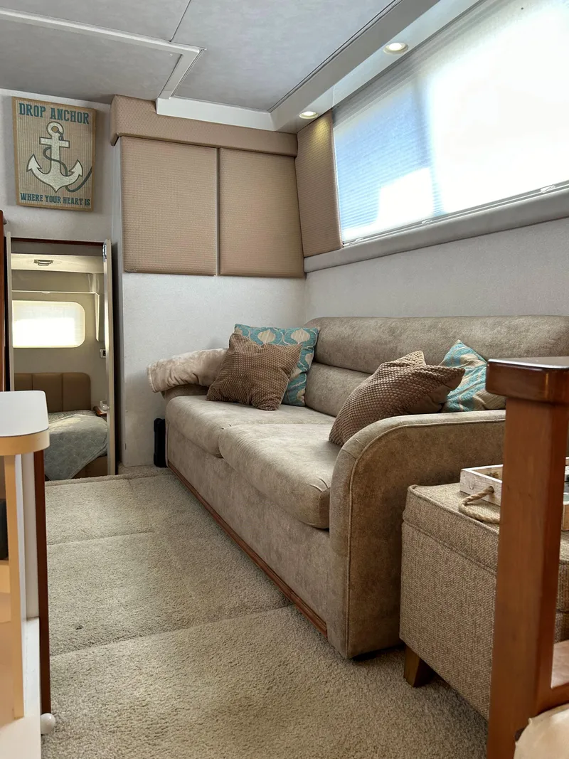 Slide: The Image of Interior of 1993 Silverton 34 Aft Cabin Motor Yacht with cozy seating and nautical decor. - 14