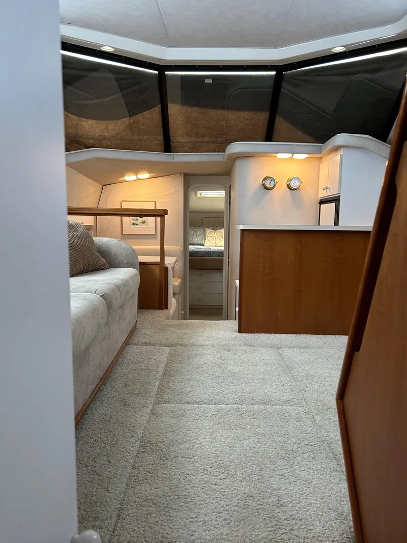 Slide: The Image of Interior of 1993 Silverton 34 Aft Cabin Motor Yacht, featuring cozy seating and modern design. - 16