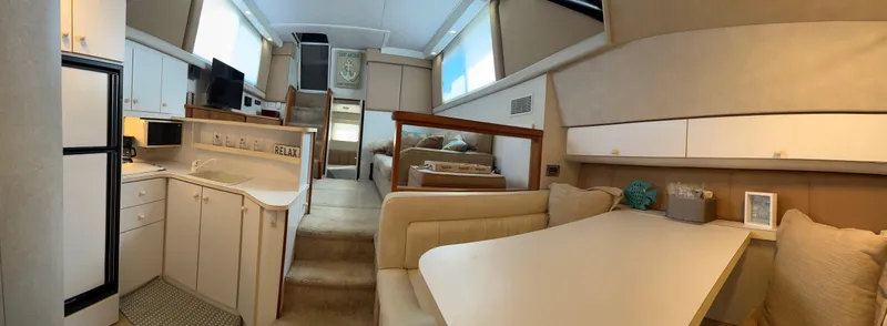 Slide: The Image of Interior of 1993 Silverton 34 Aft Cabin Motor Yacht, featuring kitchen and dining area. - 18