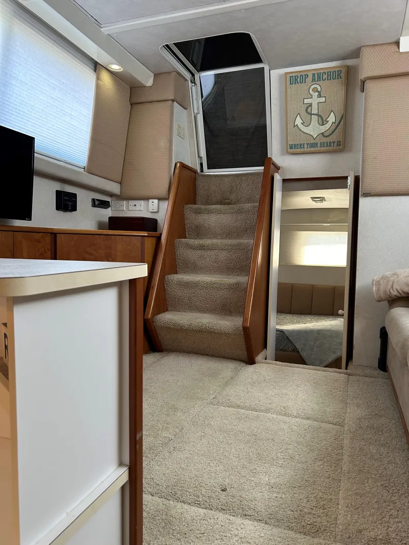 Slide: The Image of Interior of 1993 Silverton 34 Aft Cabin Motor Yacht with carpeted stairs and nautical decor. - 19