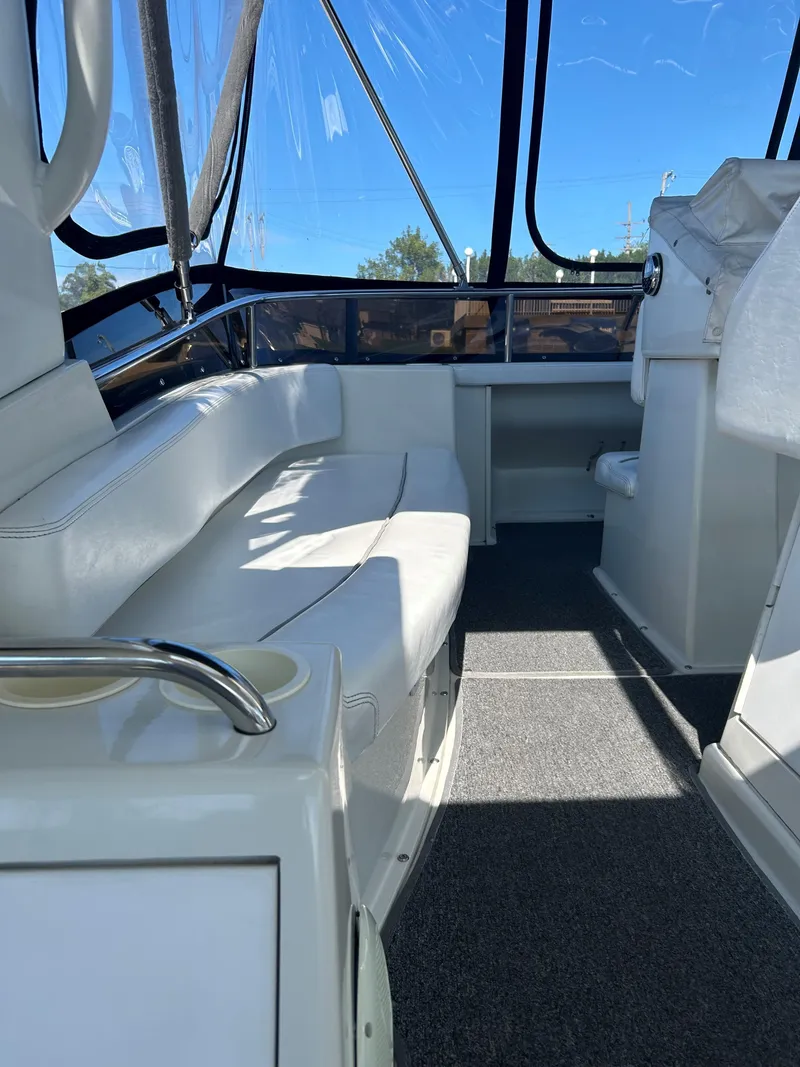 Slide: The Image of 1993 Silverton 34 Aft Cabin Motor Yacht interior with white seating and helm. - 23