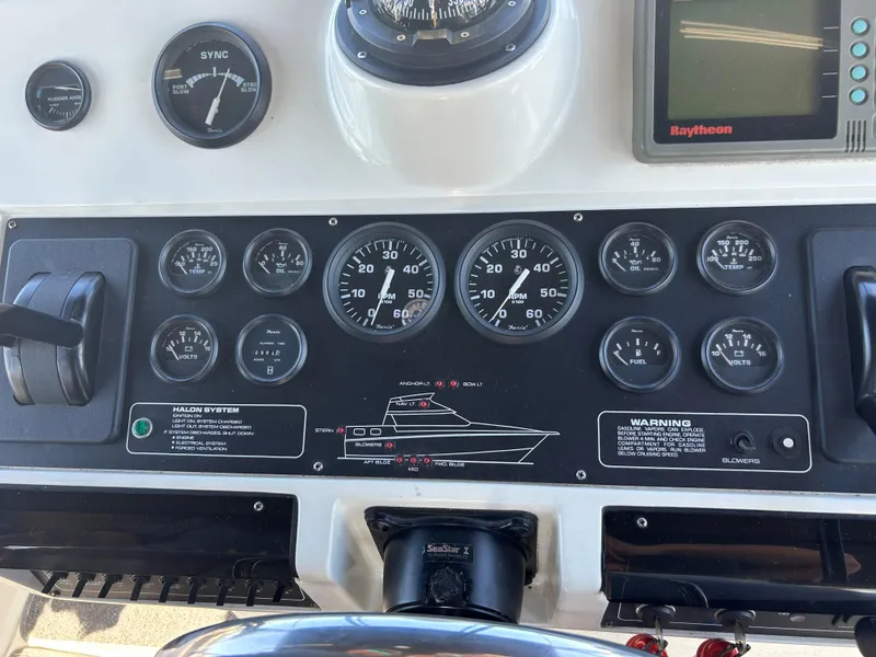 Slide: The Image of Dashboard of a 1993 Silverton 34 Aft Cabin Motor Yacht with gauges and controls. - 27