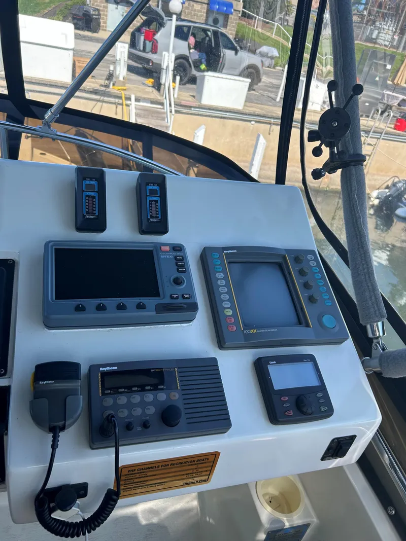 Slide: The Image of 1993 Silverton 34 Aft Cabin Motor Yacht helm with navigation equipment. - 28