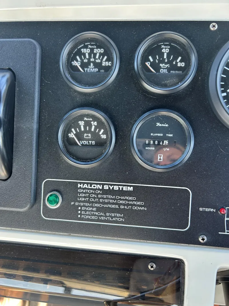 Slide: The Image of Dashboard gauges of 1993 Silverton 34 Aft Cabin Motor Yacht, featuring halon system controls. - 29