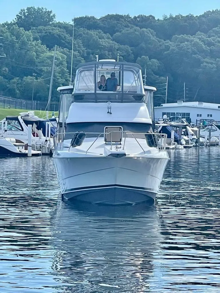 Slide: The Image of 1993 Silverton 34 Aft Cabin Motor Yacht docked in a marina. - 33