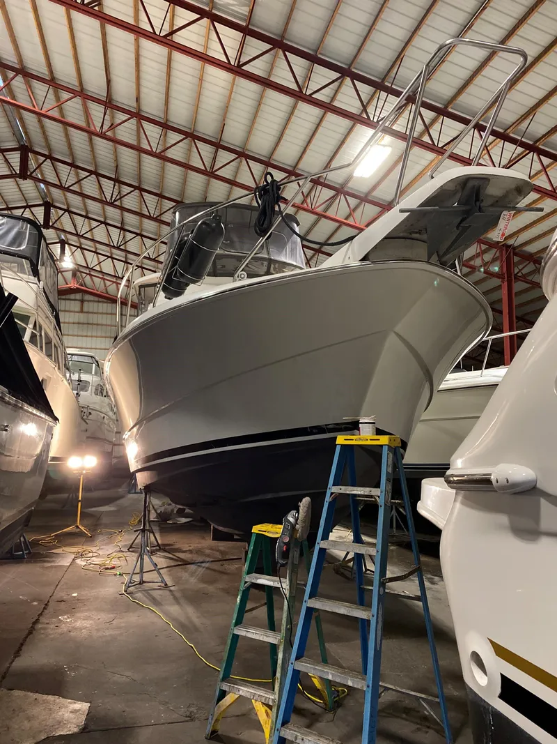 Slide: The Image of 1993 Silverton 34 Aft Cabin Motor Yacht in storage, with ladders for maintenance. - 34