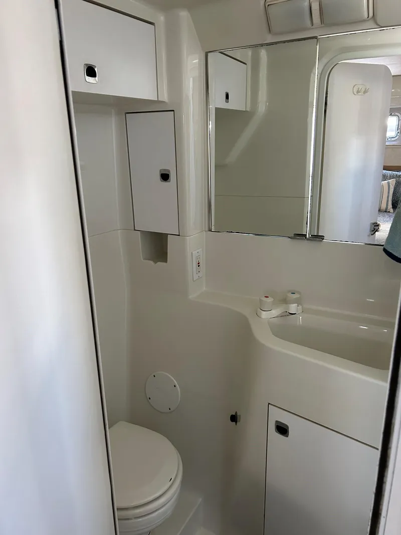 Slide: The Image of Bathroom interior of 1993 Silverton 34 Aft Cabin Motor Yacht, featuring sink and storage. - 7