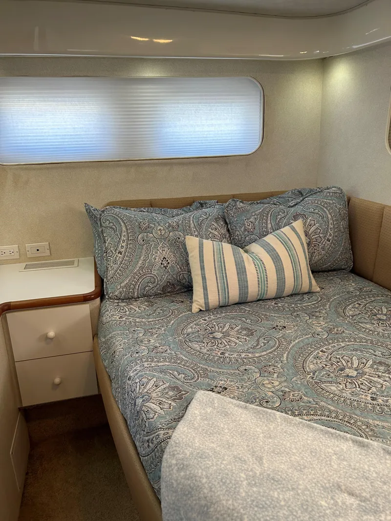 Slide: The Image of Cozy bedroom in 1993 Silverton 34 Aft Cabin Motor Yacht with patterned bedding. - 8
