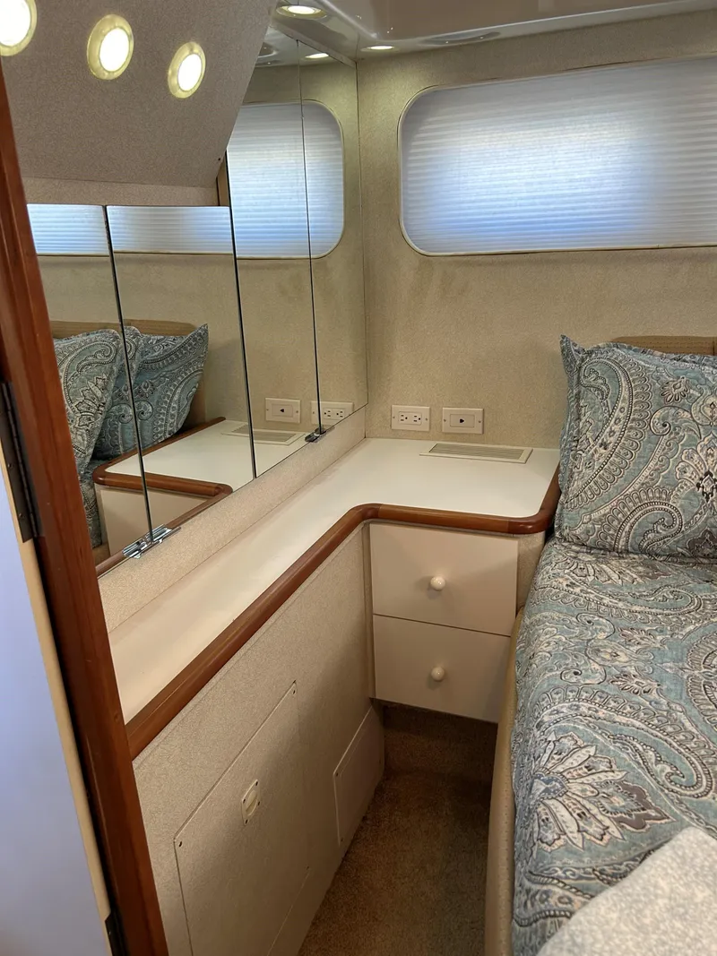 Slide: The Image of Interior of 1993 Silverton 34 Aft Cabin Motor Yacht with mirrored cabinets and patterned bedding. - 9