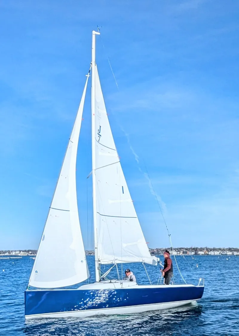 Slide: The Image of 2025 J Boats J 7 sailboat on open water under clear blue sky. - 1
