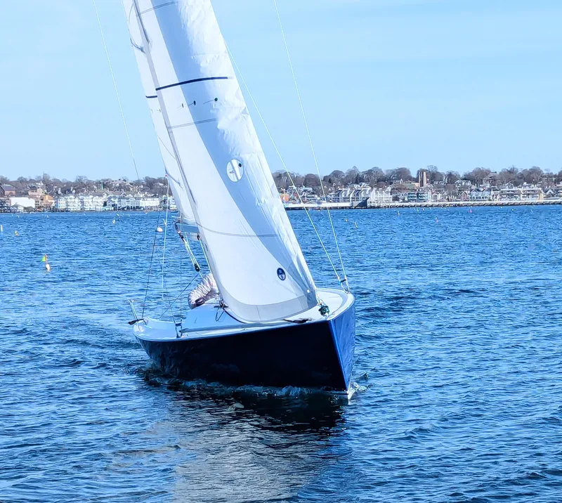 Slide: The Image of 2025 J Boats J 7 sailing on a clear blue sea near the coastline. - 3