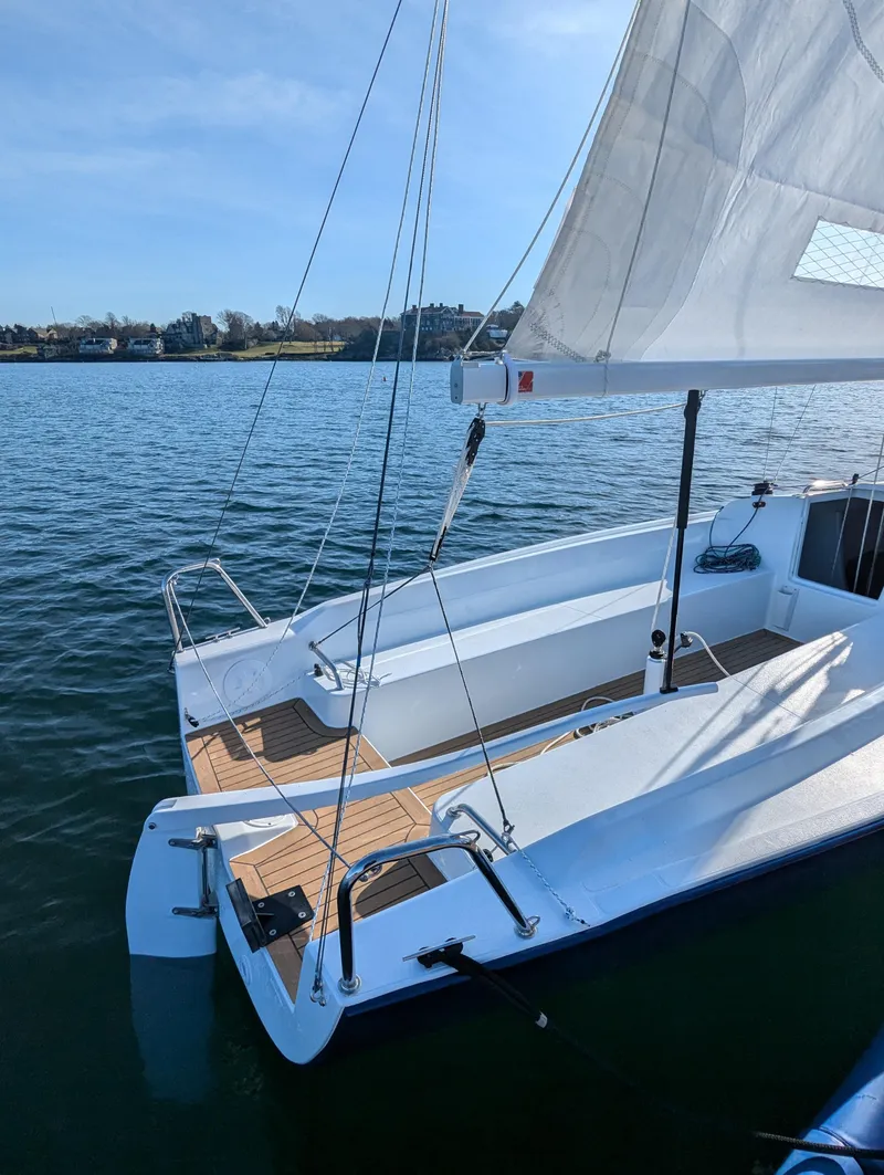 Slide: The Image of 2025 J Boats J 7 sailboat on calm water, showcasing sleek design and open deck. - 6