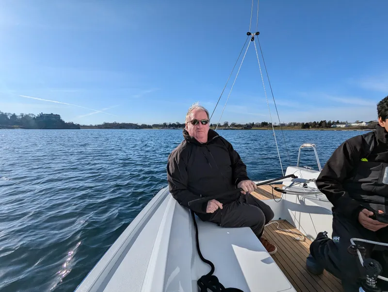 Slide: The Image of Man relaxing on a 2025 J Boats J 7 sailboat on a sunny day. - 7