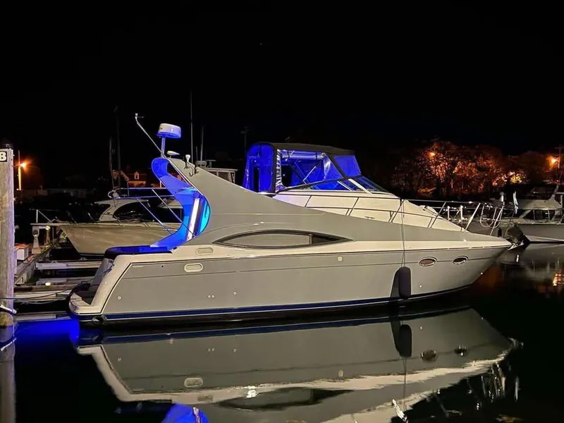 Slide: The Image of 1997 Carver 350 Mariner yacht illuminated at night in a marina. - 0