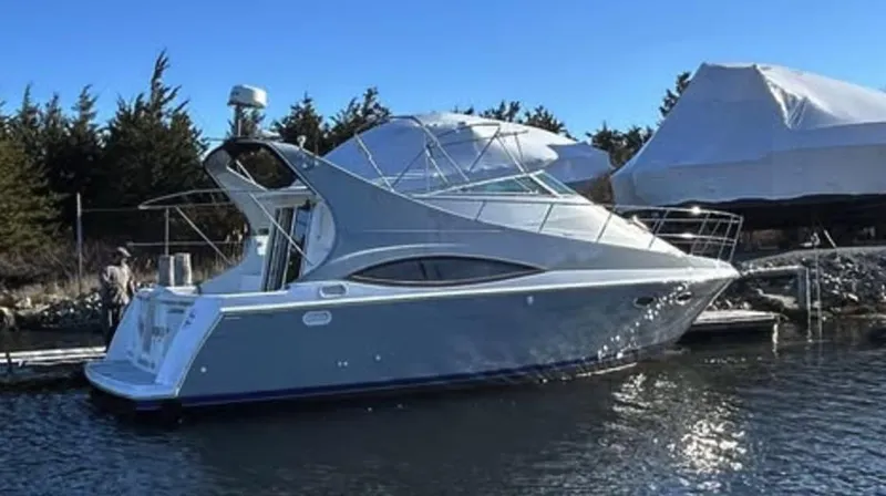 Slide: The Image of 1997 Carver 350 Mariner yacht docked in a serene marina setting. - 1