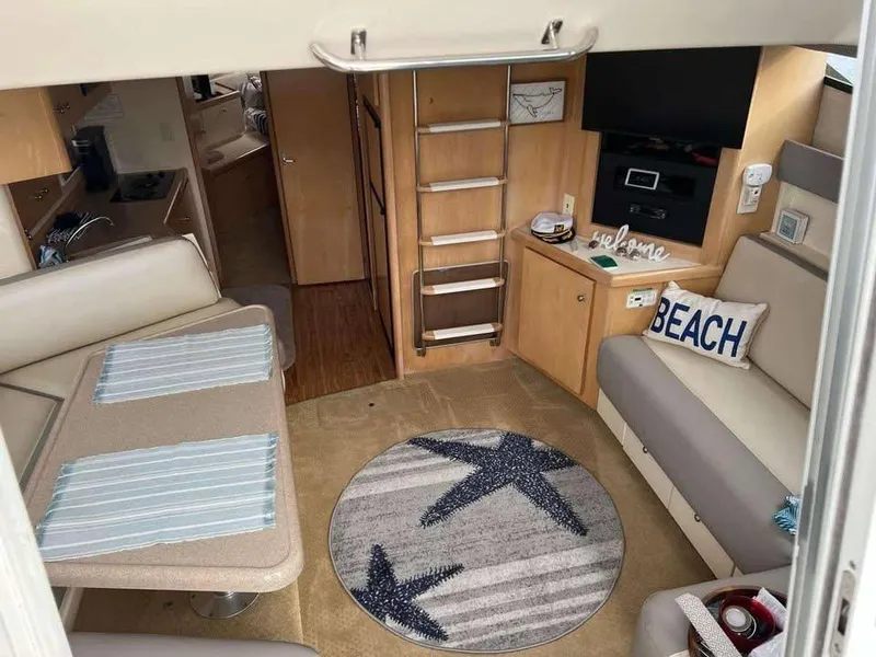 Slide: The Image of Interior of 1997 Carver 350 Mariner yacht with cozy seating and nautical decor. - 11