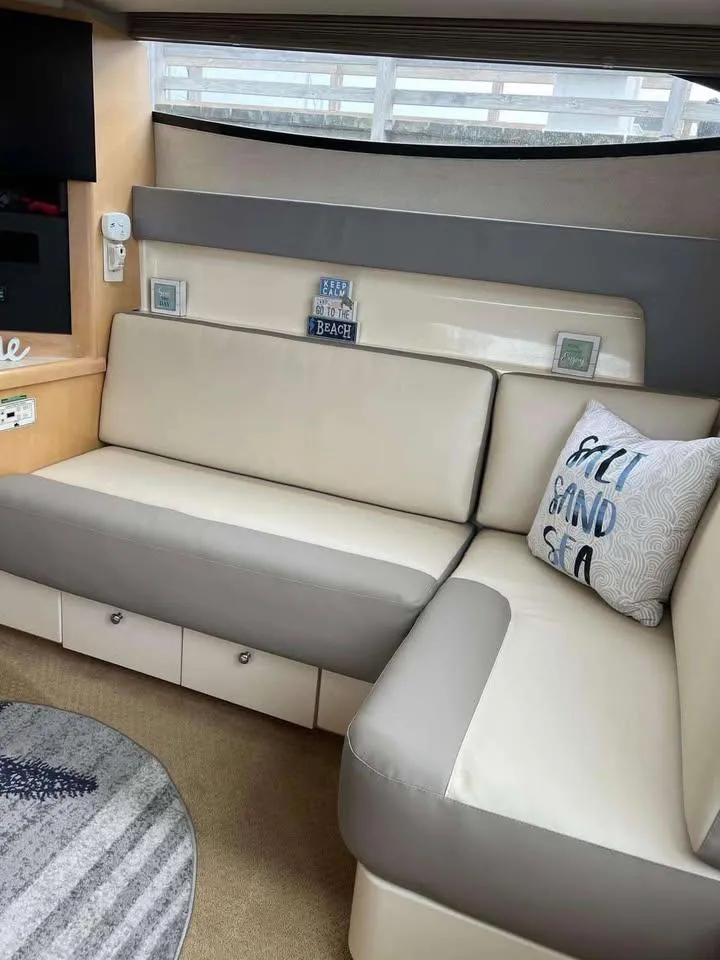 Slide: The Image of Interior of 1997 Carver 350 Mariner yacht with beige seating and nautical decor. - 12