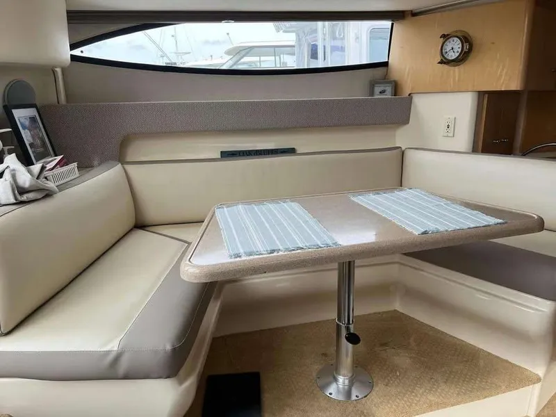 Slide: The Image of Interior of 1997 Carver 350 Mariner with beige seating and dining table. - 14