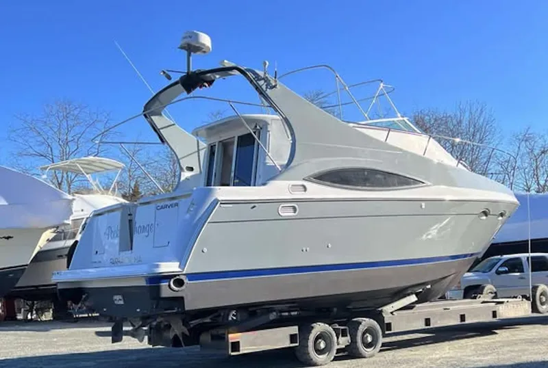 Slide: The Image of 1997 Carver 350 Mariner yacht on trailer under clear blue sky. - 2