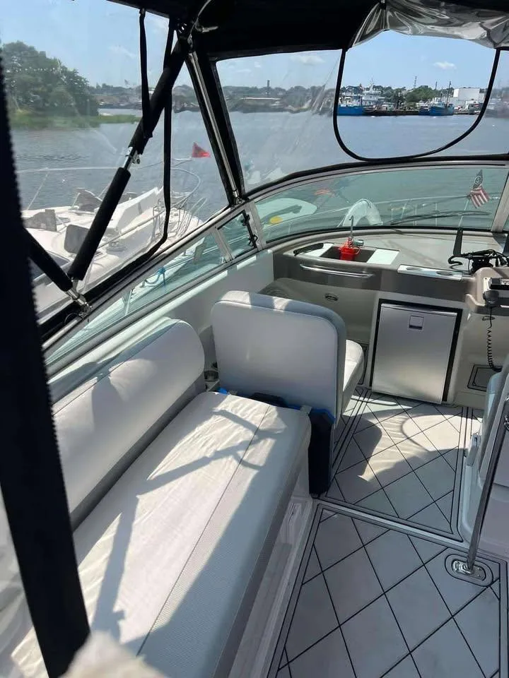 Slide: The Image of 1997 Carver 350 Mariner interior with seating and helm, overlooking water. - 4