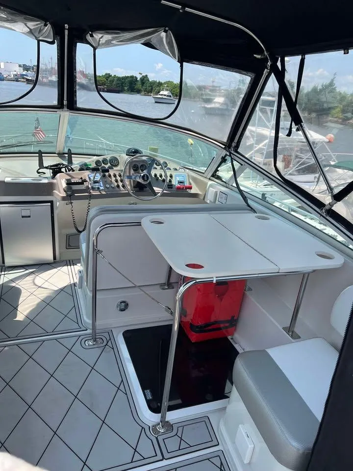 Slide: The Image of 1997 Carver 350 Mariner boat interior with helm, seating, and table. - 5