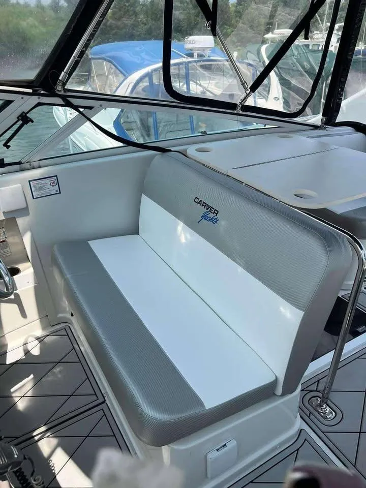 Slide: The Image of 1997 Carver 350 Mariner boat interior with cushioned seating and helm area. - 6