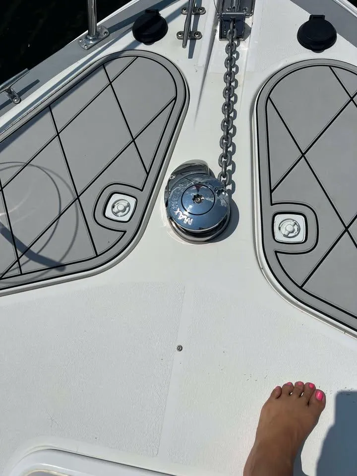 Slide: The Image of 1997 Carver 350 Mariner boat deck with anchor chain and foot visible. - 9