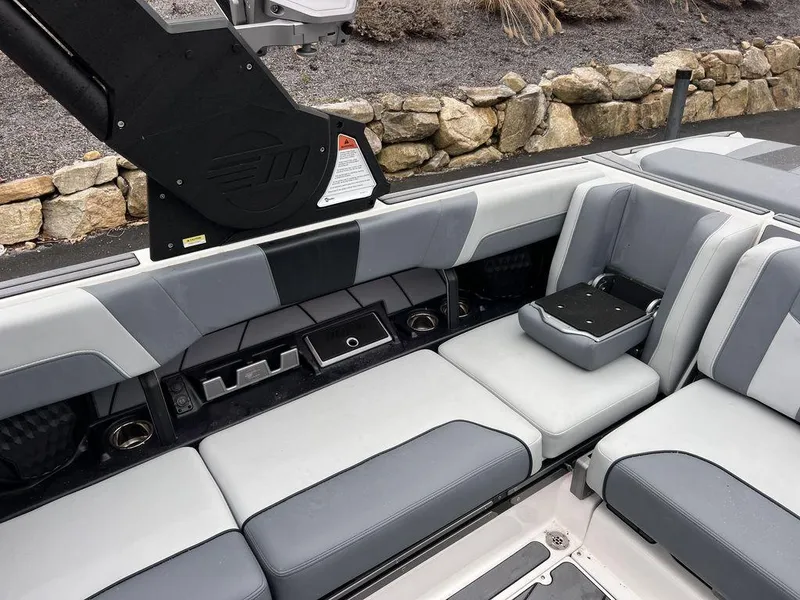 Slide: The Image of 2023 Malibu 23 LSV boat interior with gray seating and modern design. - 18