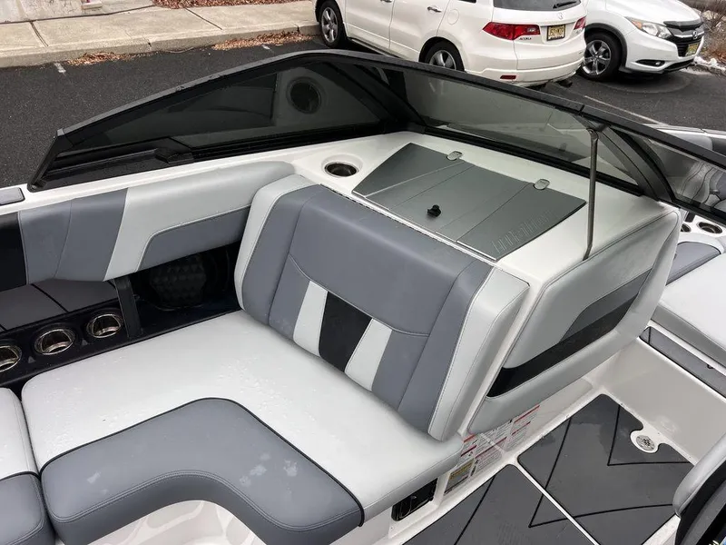 Slide: The Image of 2023 Malibu 23 LSV boat interior with sleek gray and white seating design. - 26