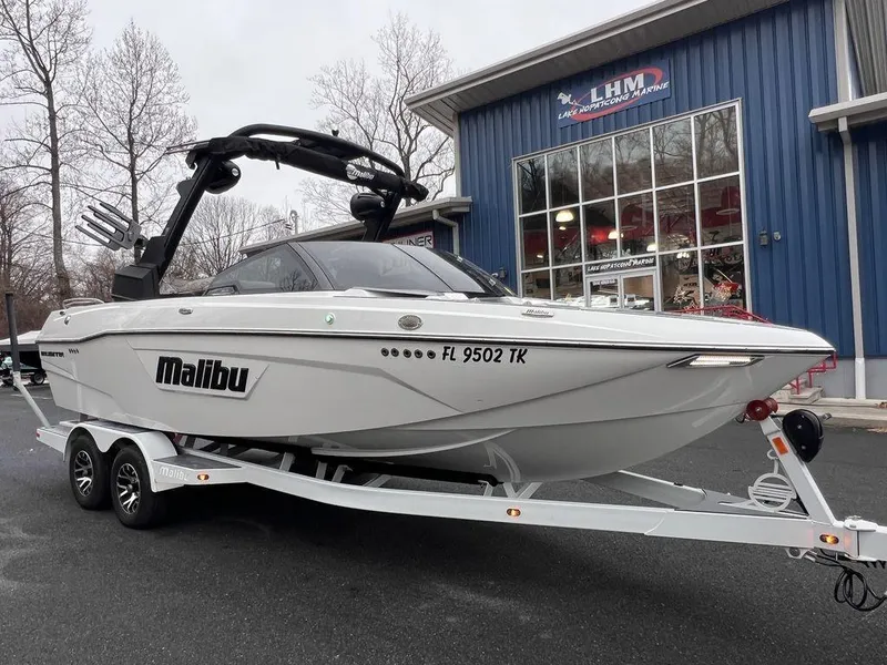Slide: The Image of 2023 Malibu 23 LSV boat on trailer outside dealership. - 3