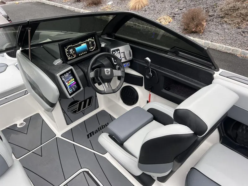Slide: The Image of 2023 Malibu 23 LSV boat interior with modern dashboard and steering wheel. - 5