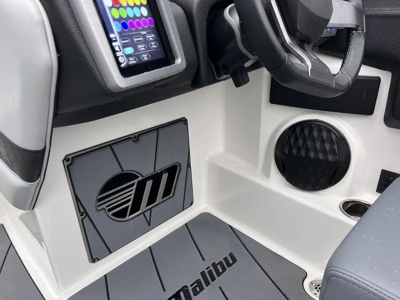 Slide: The Image of 2023 Malibu 23 LSV boat interior with touchscreen controls and branded flooring. - 7