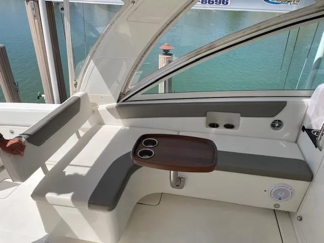 Slide: The Image of 2019 World Cat 320 DC boat interior with seating and cup holders. - 10