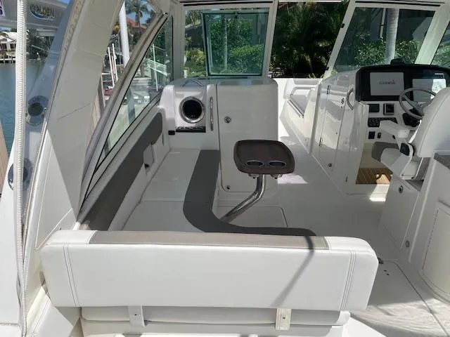 Slide: The Image of Interior of 2019 World Cat 320 DC boat with seating and helm. - 11