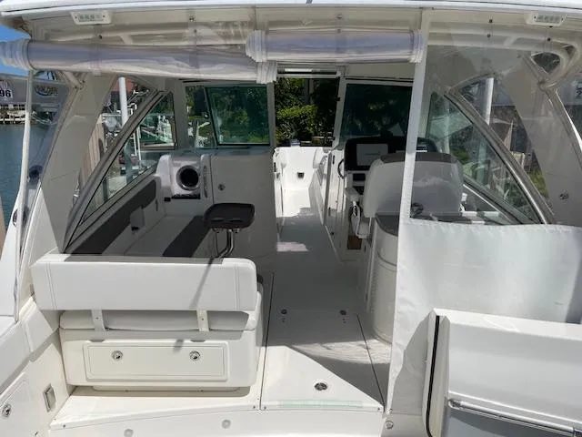 Slide: The Image of 2019 World Cat 320 DC boat interior with seating and helm. - 12