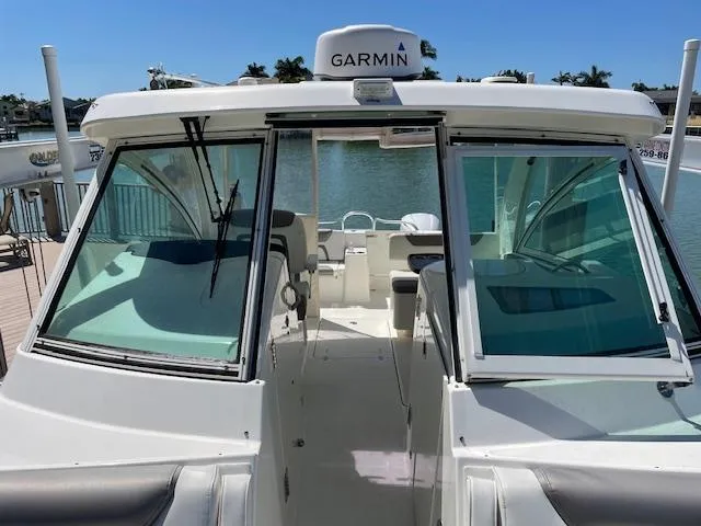 Slide: The Image of 2019 World Cat 320 DC boat with Garmin equipment, docked by the water. - 6