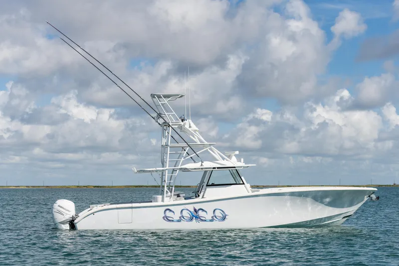 The Image of 2019 Yellowfin 42 Center Console boat on calm water under cloudy sky. - 1