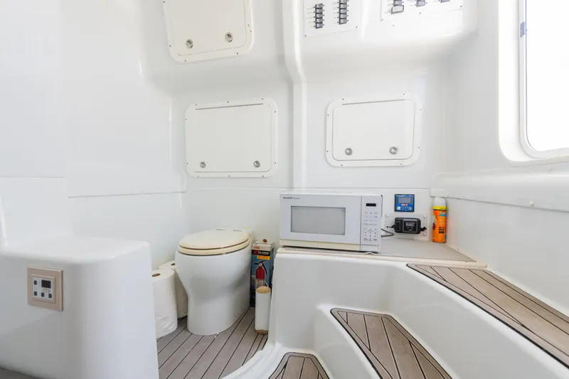 Slide: The Image of 2019 Yellowfin 42 Center Console interior with toilet, microwave, and storage compartments. - 17