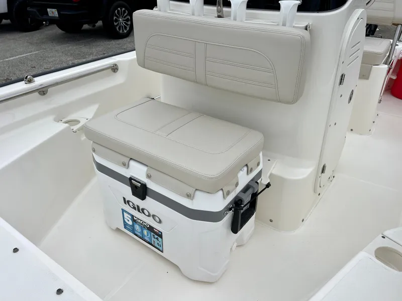 Slide: The Image of 2025 Boston Whaler 150 Montauk interior with Igloo cooler and cushioned seating. - 10