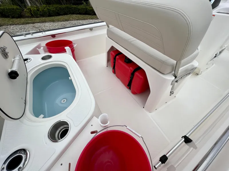 Slide: The Image of 2025 Boston Whaler 150 Montauk interior with storage and seating. - 13