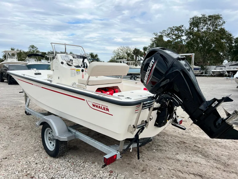 Slide: The Image of 2025 Boston Whaler 150 Montauk boat on trailer, featuring Mercury outboard motor. - 6