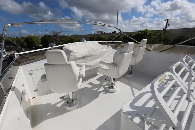 Slide: The Image of Flybridge seating on 1988 Broward 124 Tri-Deck MY yacht under blue sky. - 14
