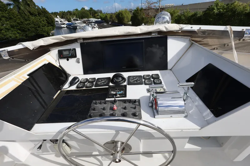 Slide: The Image of Cockpit of 1988 Broward 124 Tri-Deck MY yacht with navigation controls and steering wheel. - 16