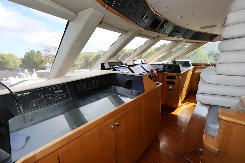 Slide: The Image of Interior helm of 1988 Broward 124 Tri-Deck MY yacht with wooden cabinetry and navigation equipment. - 17