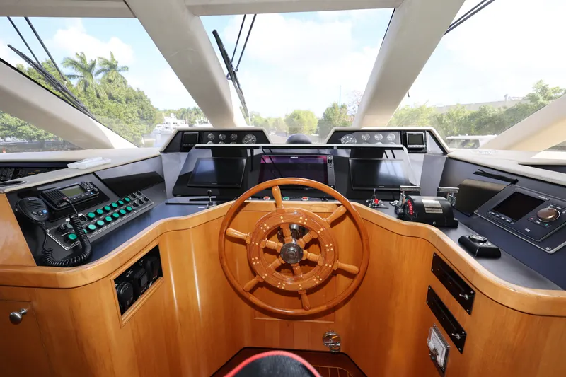 Slide: The Image of Helm of 1988 Broward 124 Tri-Deck MY yacht with wooden steering wheel and control panels. - 20